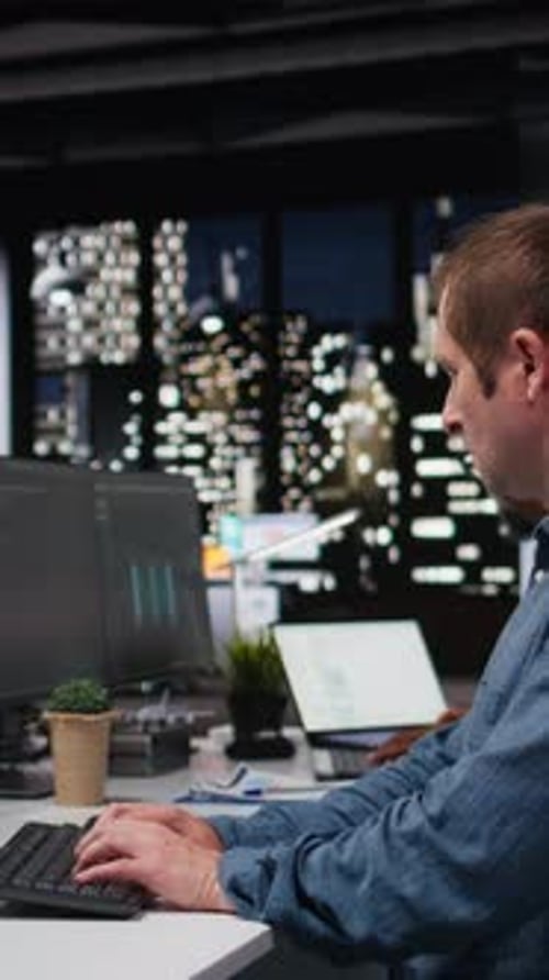 Vertical Video System Administrators in Office Working Together to Block Hacker Intrusion