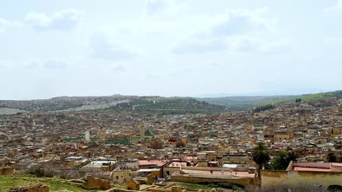 The panoramic view of Fez, Morocco, is warm and beautiful on this sunny day, with countless houses a