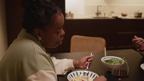 Adults Having Dinner at Home Eating Salad