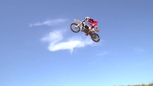 Dirt Bike Rider Performing Stunt on Rural Track