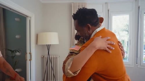 Woman in Uniform Hugs Family in Home