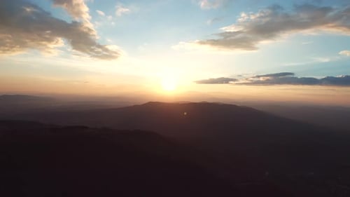 sunrise over foggy mountains