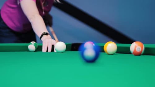 White Ball Strikes Blue Ball in Slow Motion with Dramatic Focus Shift