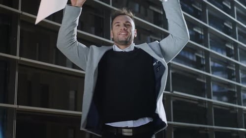 Happy Businessman Throwing Documents on City Street. Smiling Male Manager Celebrating Success