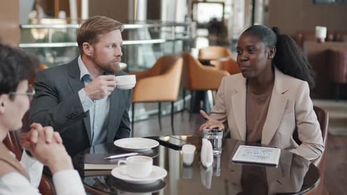 Multi-ethnic Business People Having Meeting In Restaurant