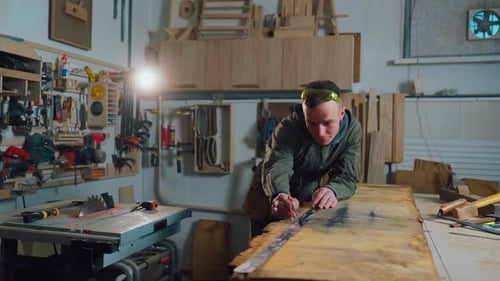 Carpenter Man Working With Wood in Workshop
