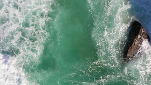 Amazing Top Down Aerial View of Deep Blue Ocean Waves Filming the Movement of Waves on Stones