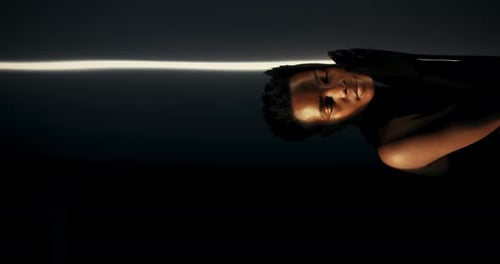 Stylish Young Adult Smiles in Moody Lighting