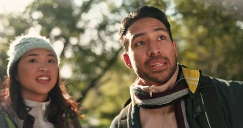 Hiking, couple and outdoor view in woods with pointing on a backpack journey together in nature