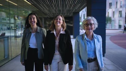 Three Only Business Women in Suits Walking Confident Looking Happy at Camera Outside Office Center