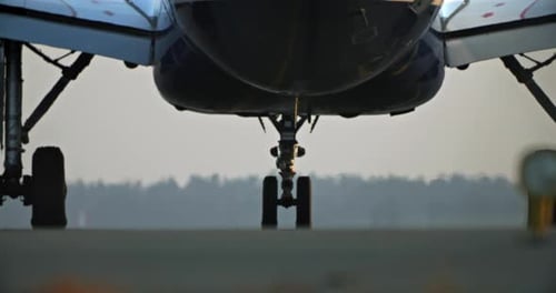 A Closeup of the Wheels of an Airplane That is Preparing to Take Off