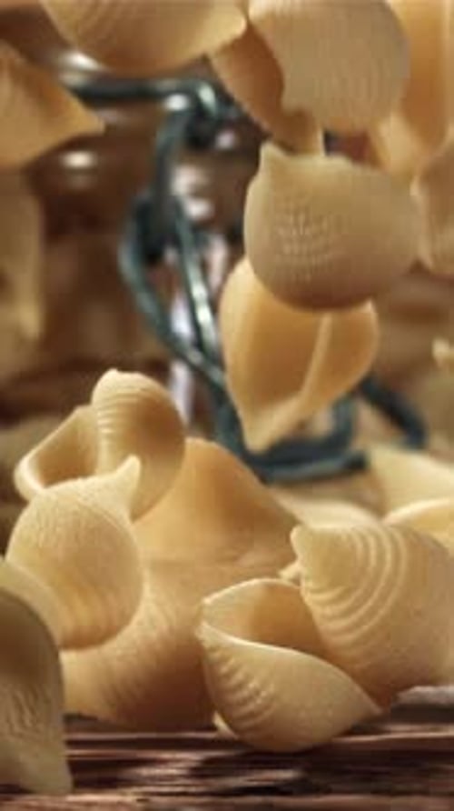 Dry Pasta Falls on a Wooden Table Filmed on a Highspeed Camera at 1000 Fps