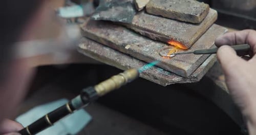 Jeweler Solders a Silver Blank with a Gas Burner in the Process of Creating a Jewelry Ring