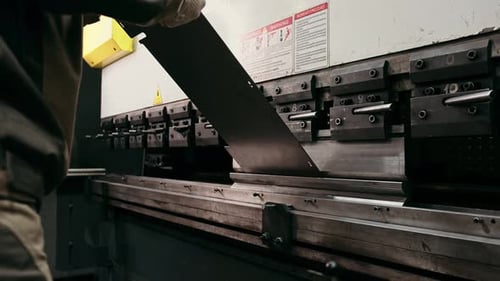Worker Operating Bending Machine in Factory Setting
