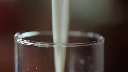 Close up shot of white milk poured in a glass