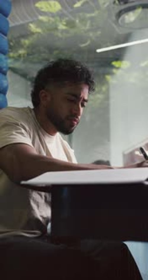 Writing, office and business man in cubicle for story feedback, review article and editing report