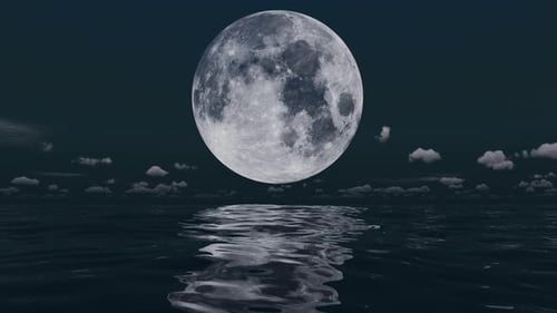 Huge moon over the sea at night and clouds.