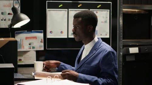 Professional Man Working at Desk, Drinking Coffee