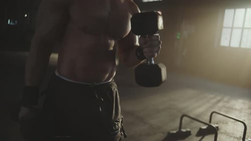 Muscular Man Lifting Weights in Industrial Gym