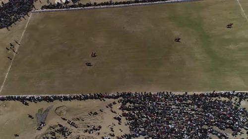 Aerial view of crowd and horses at Shandur Pass event, Pakistan.