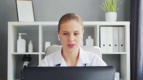 Doctor Works in the Medical Office Woman in White Coat Workplace of a Professional Female Therapist