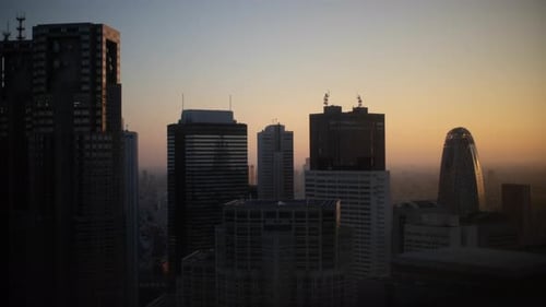 Aerial Footage of the Big City in the Dusk or Early Morning. Skyscrapers in the Sun with Skyscape.
