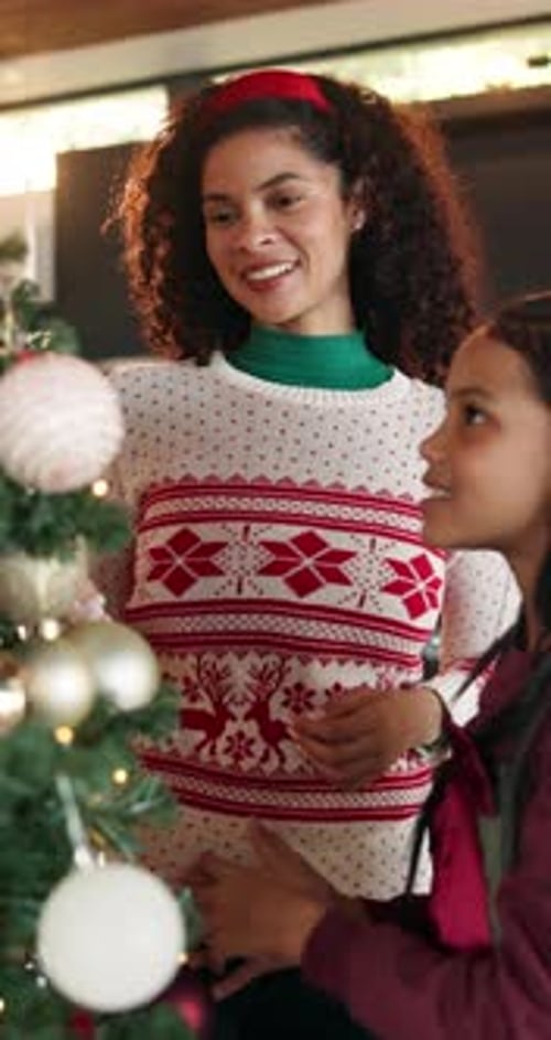 Happy mom, child and christmas tree with bauble for festive decoration or celebration together