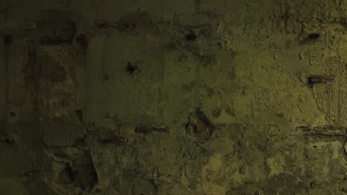 Cinematic aerial drone footage gliding through an abandoned factory interior. Slow and atmospheric