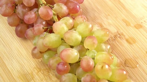 Fresh bunches of grapes of green sort rotate as a background. Grape close up, concept winemaking