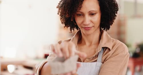 Boutique, creative and pottery with woman shaping clay in gallery for crafting
