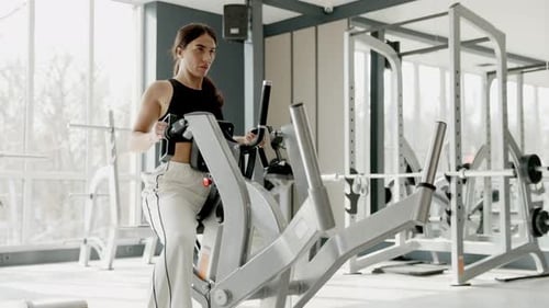 An Active Fit Woman Utilizing Gym Equipment Effectively for Her Strength Training Routines