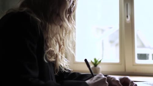 Young Woman Working on Her Laptop Computer in Coffee Shop