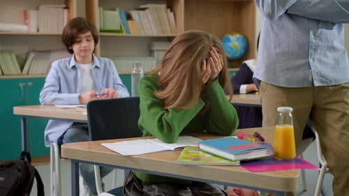 Elementary School Class Children Communicate with the Teacher Answering Question