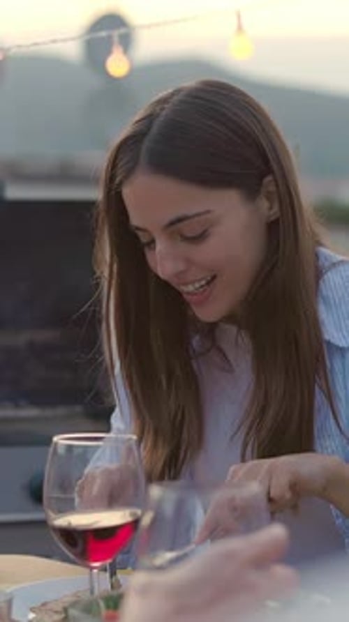 Young Group of Friends Having Barbecue Dinner Party at Terrace Rooftop in Summer