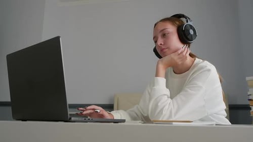 Teenage Girl Studying at Laptop at Home