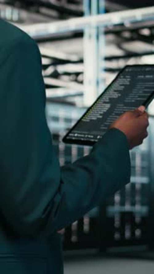 Vertical Video Close Up of Data Center Programmer Using Tablet App to Write Code