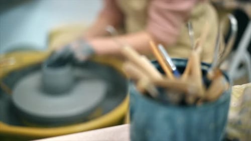 The master of sculpting pottery working and tools in a studio