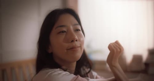 Tracking Close Up Beautiful Korean Woman Waking up in the Morning, Doing some Stretching, Apprecia