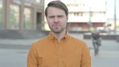 Sad Young Man Crying while Standing Outdoor