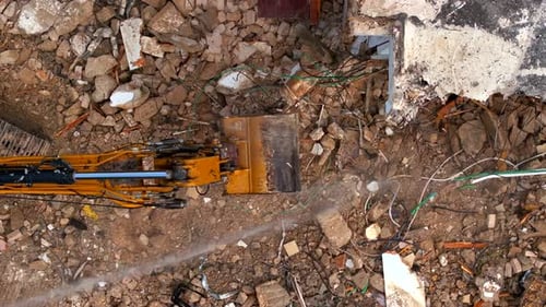 Excavator arm demolishing an old building, Aerial view