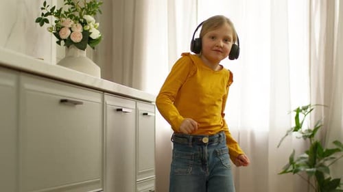 Young Girl Dancing and Listening to Music at Home