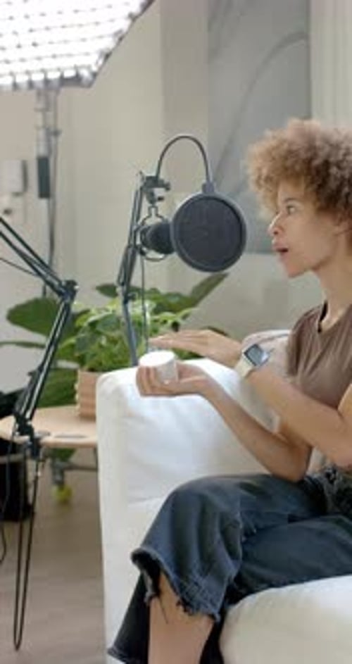 Vertical video: Mics are capturing jar demo after jar lift for podcast with coffee table nearby