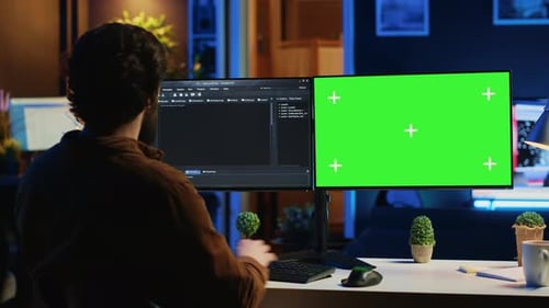 Software Programmer Writing Lines of Code on Chroma Key Computer at Home