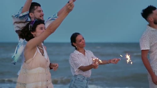 Friends Celebrate with Sparklers on the Beach