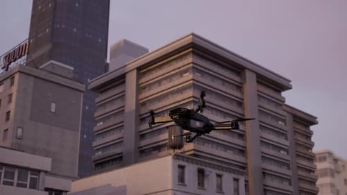 Police Surveillance Drone Against Urban Building at Sunset