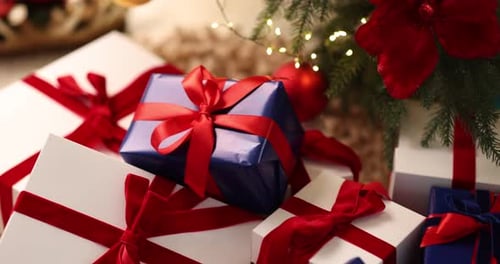 Christmas Gifts Under Tree with Red Ribbons