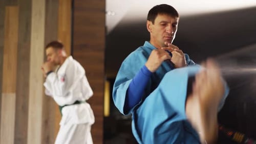 Man Demonstrates Martial Arts Techniques in a Gym
