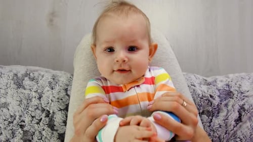 Fair-haired Baby Playing With its Hands