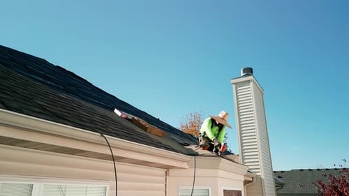 Roofer Repair or Replace Shingle That Has Been Damaged and Needing Replacement at Sunny Day