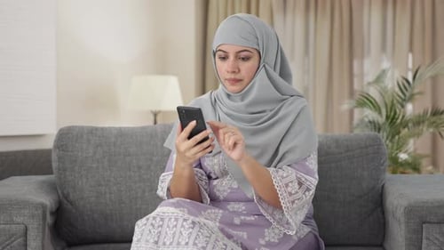 Muslim woman using mobile phone